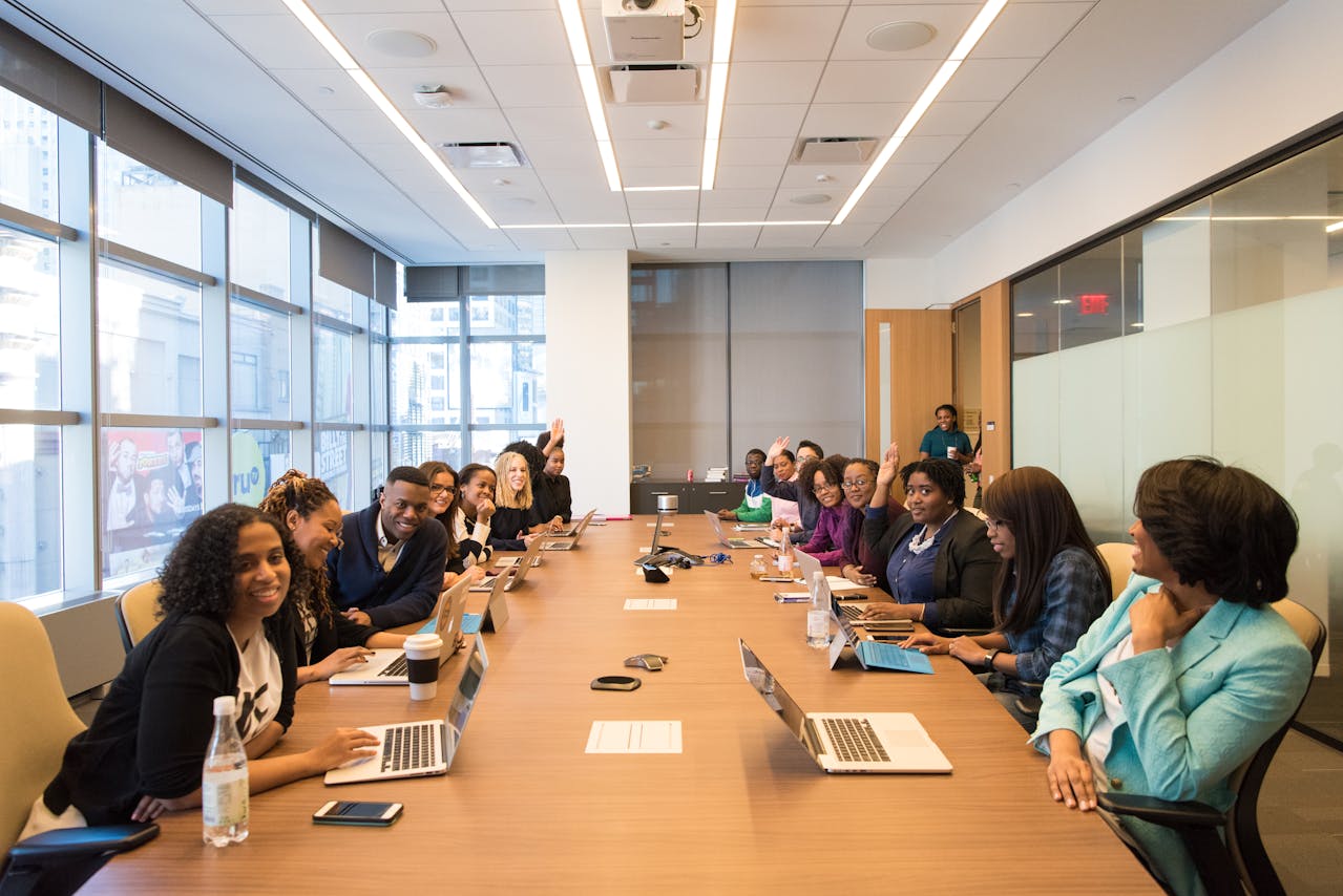 A diverse group of professionals engaged in discussion around a conference table at Athena Best Painting Services.