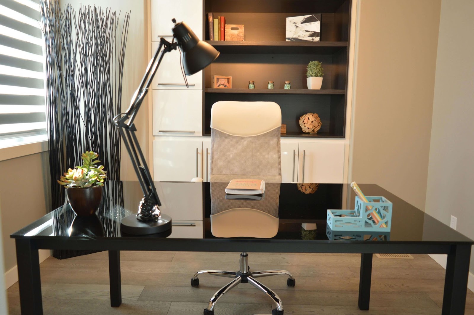 A sleek black desk paired with a modern white chair, reflecting contemporary commercial painting trends in office design.