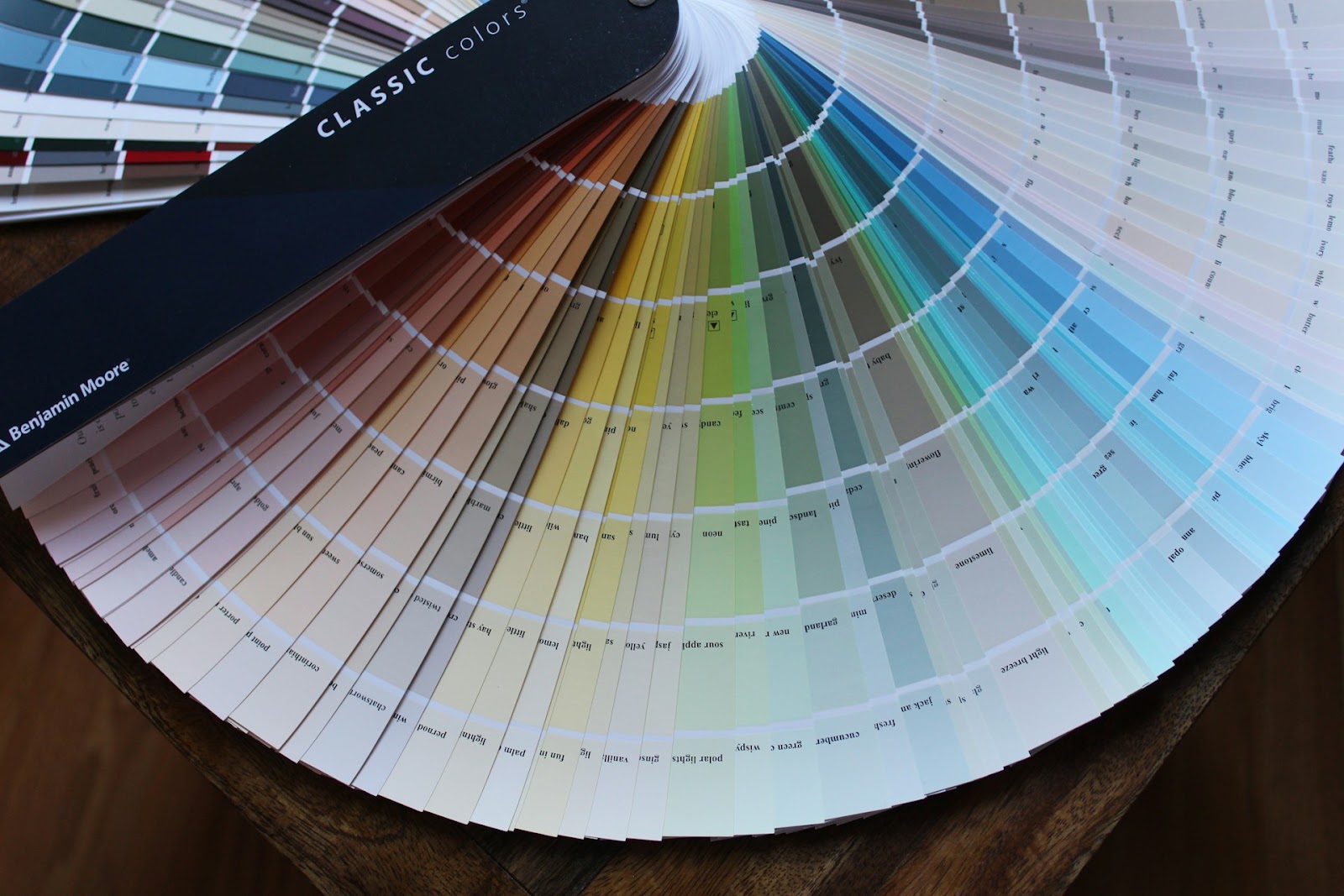 Detailed close-up of a color swatch book, highlighting diverse colors for Athena Best Painting Services' color analysis in Singapore.