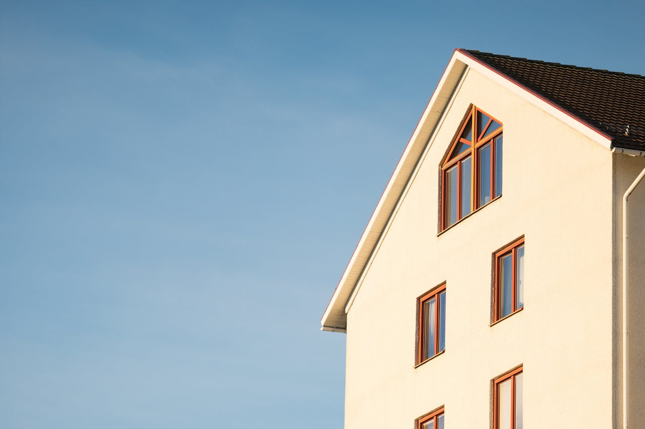 A white building featuring a prominent red window, showing the quality of Athena Best Painting Services.