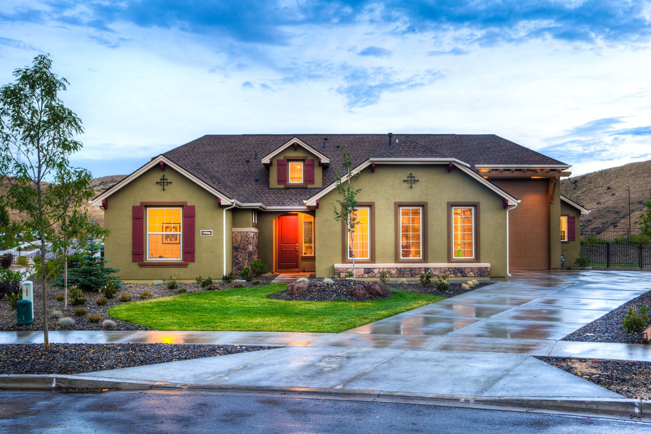 A house featuring a driveway and a front yard, showing the quality of Athena Best Painting Services.