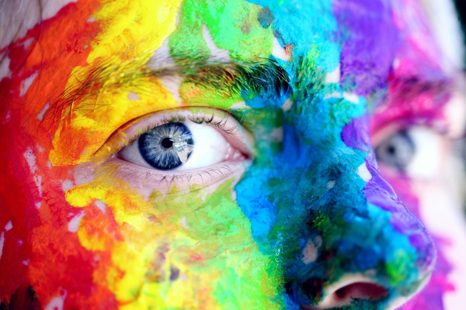 A close-up image of a person's face featuring artistic paint designs, reflecting current trends in commercial painting.
